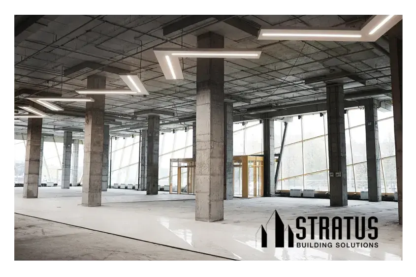 Large Office Interior Under Construction with Open Beams and Concrete Floors in Need of Cleaning